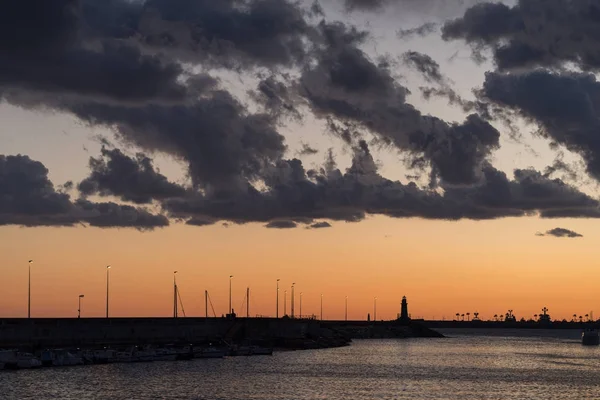 Stormy clouds of contrasting color over the harbour — Stock Photo, Image