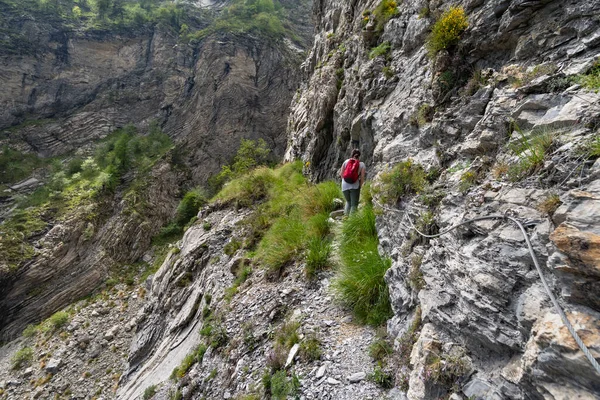 Female hiker on mountain pathway, Ligurian Alps, Italy