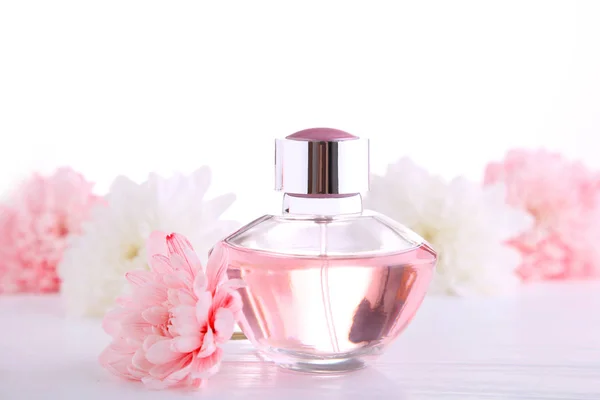 Butelka perfum z kwiatami na białym tle, widok z góry — Zdjęcie stockowe