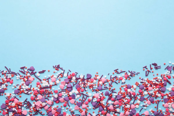 stock image Colorful sprinkles on a blue background, top view with copy space