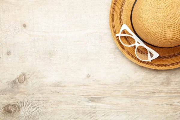 Vintage fabricate straw hat and sunglasses on light background, cut out