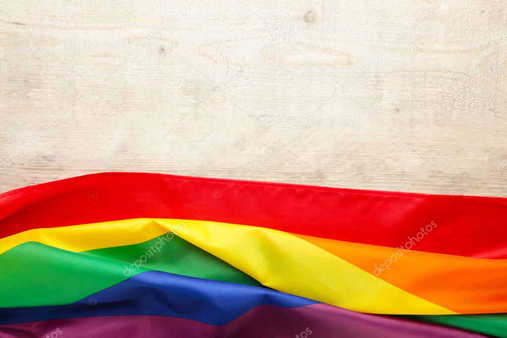 Rainbow LGBT flag on light background, top view