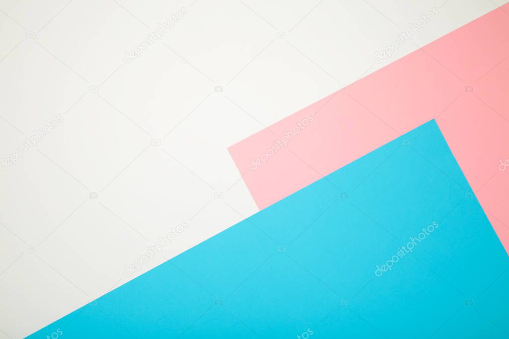 Blue, white and pink color paper geometric flat lay background with copy space