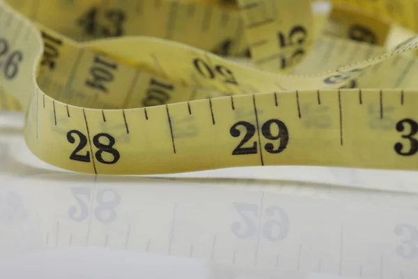 Close up shot of measurement tape isolated on white background