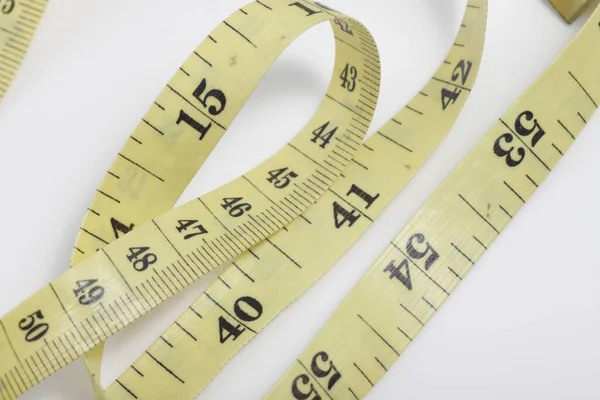 Close up shot of measurement tape isolated on white background