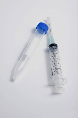 Tıbbi şırınga ve test tüpünü yakın plan beyaz arka planda izole edilmiş laboratuvar test amacıyla çek.