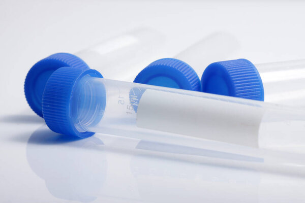 Close up shot of empty plastic test tube with blue lid for medical and laboratory testing purpose