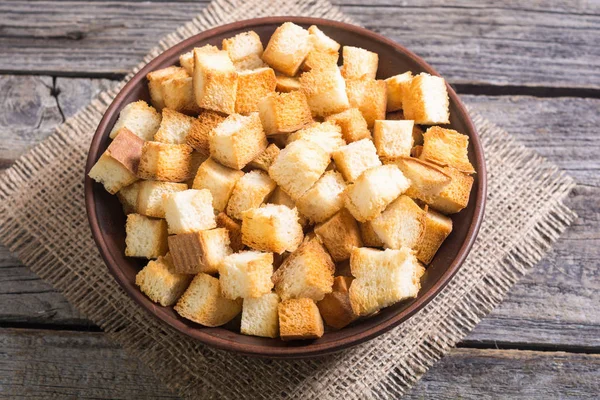 Crispy croutons in bowl — Stock Photo, Image