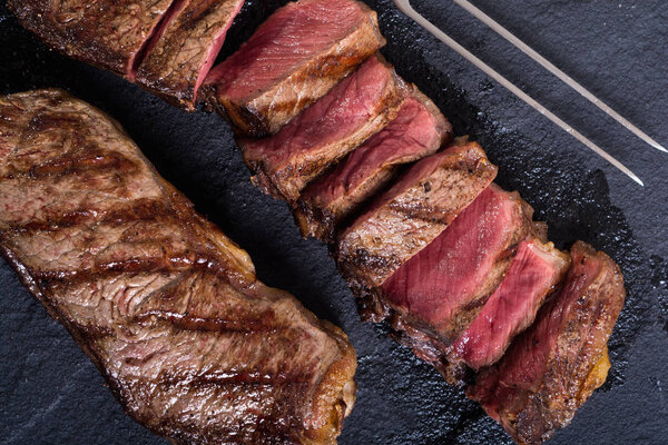 Grilled New York steak meat . Food background
