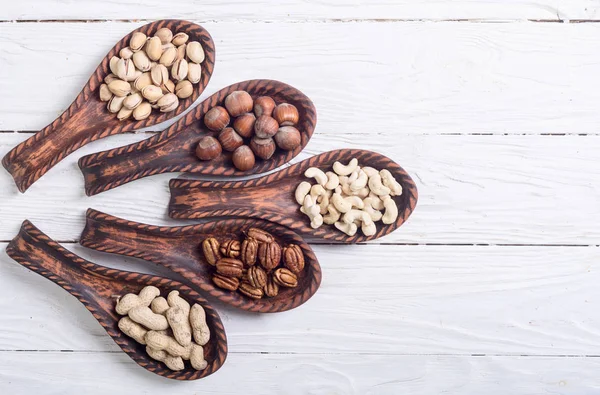 Mix of nuts in wooden spoon — Stock Photo, Image