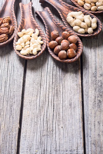 Mix of nuts in wooden spoon — Stock Photo, Image