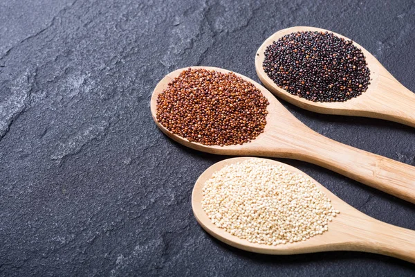 Black , white and red quinoa in spoon — Stock Photo, Image