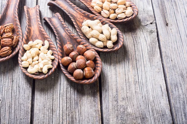 Mix of nuts in wooden spoon — Stock Photo, Image