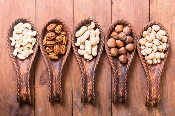 Mix of nuts in wooden spoon — Stock Photo, Image