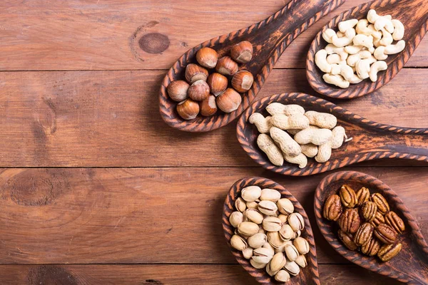 Mix of nuts in wooden spoon — Stock Photo, Image