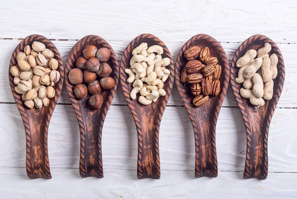 Mix of nuts in wooden spoon — Stock Photo, Image