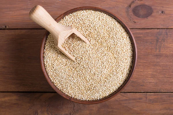 White  quinoa in bowl on wooden background — Stock Photo, Image