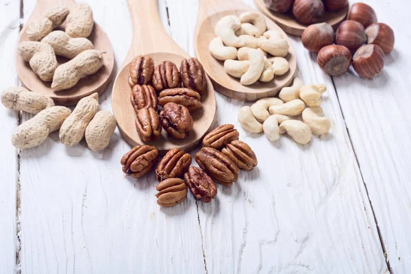 Mix of nuts in wooden spoon — Stock Photo, Image