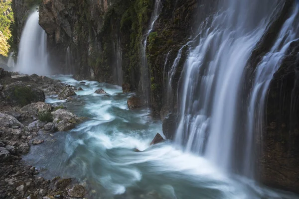 Massive waterfall with blue river — Stock Photo, Image