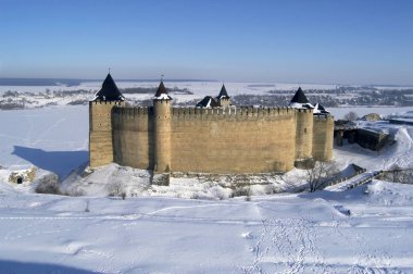 Khotyn fortress in the middle of a snowy landscape clipart