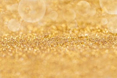 Bokeh soyut veya doku arkaplanı olan altın tozu