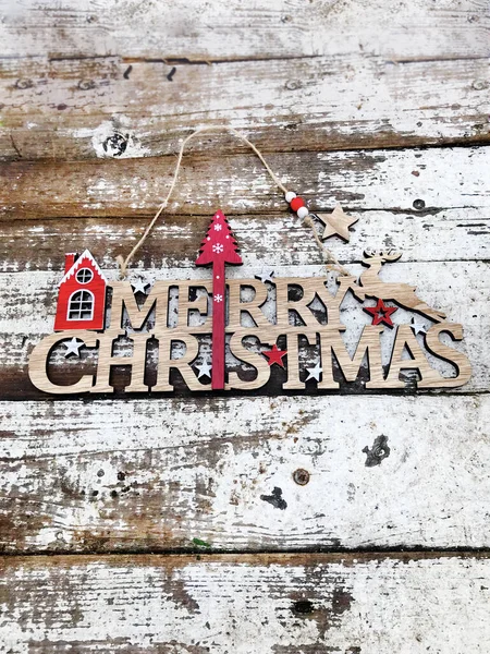 Wooden Merry Christmas Sign on a Rustic Wooden Background