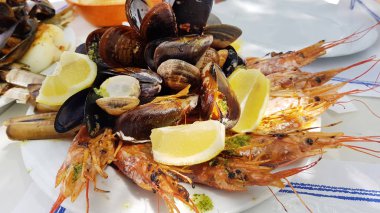 seafood dishes with baked mussels and shrimps with lemons and sauces