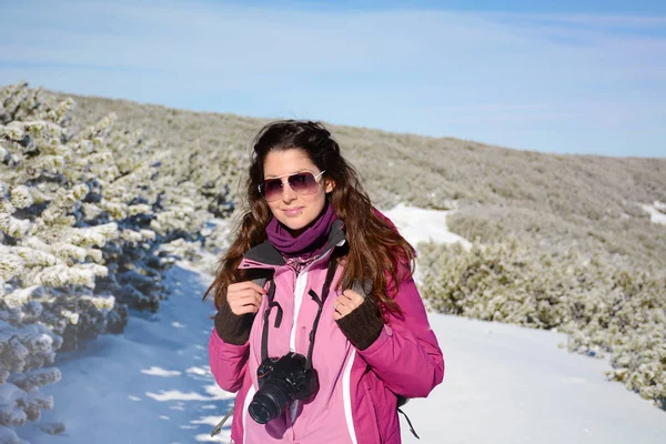 attractive young woman in winter cloth and glasses on snowy background