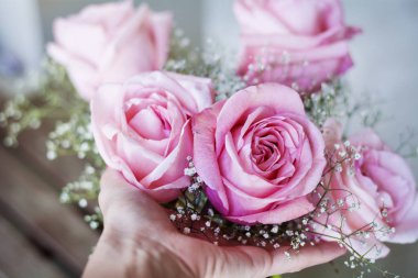 beautiful bouquet of pink roses on table background