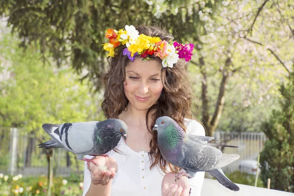Beautiful Woman with Spring Wreath  Feeding Pigeons