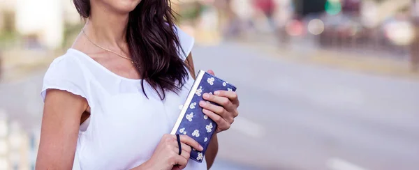 Young Woman with Wallet in the Hands on the Street. Unrecognizable People