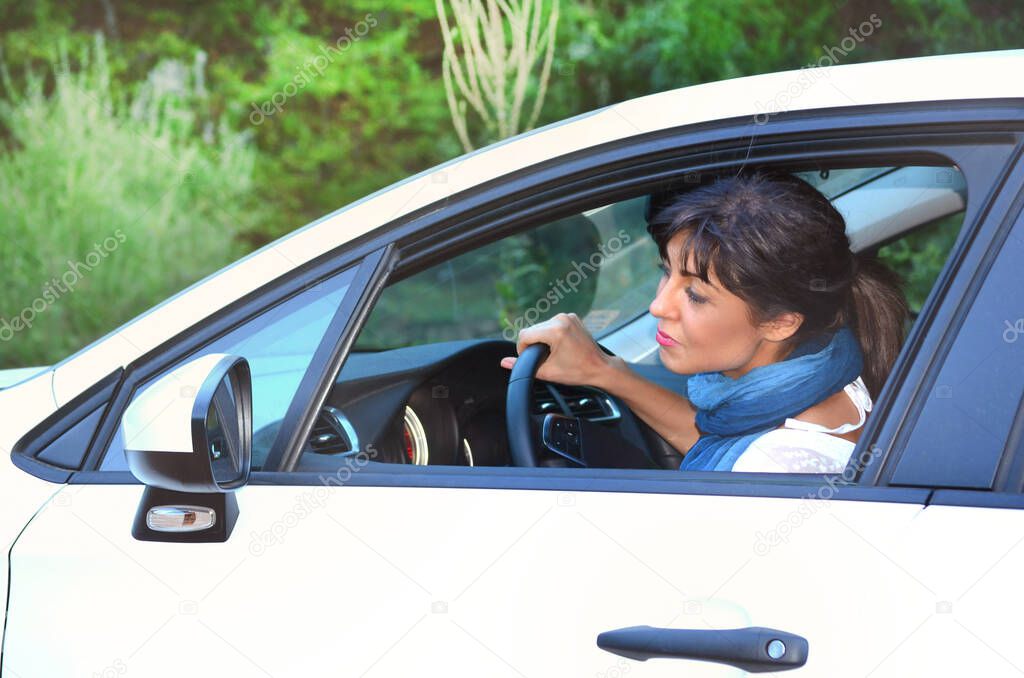 Young Woman Parking White Car .Learning to Drive Concept 