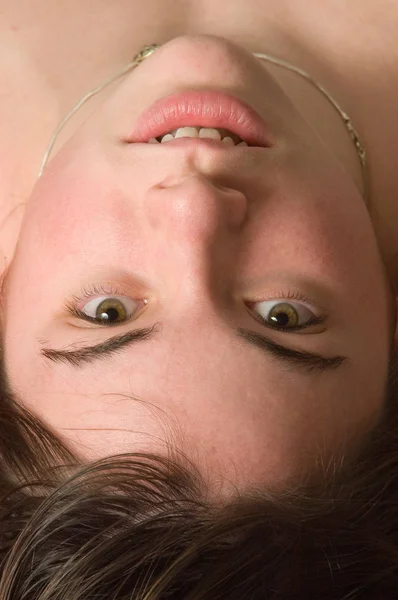 Woman looking into camera upside-down Royalty Free Stock Images