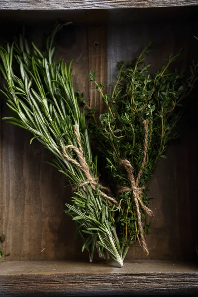 Bunches of Rosemary and thyme in crate — Stock Photo, Image