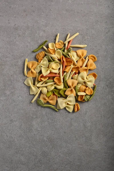 Raw pasta on gray  concrete background — Stock Photo, Image