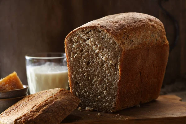 Loaf of rustic rye bread and milk — Stock Photo, Image