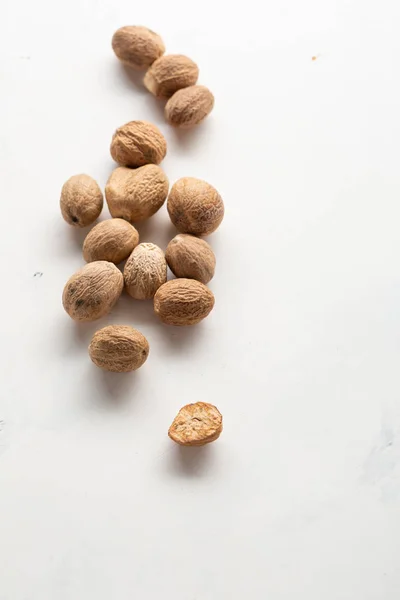 Aromatic nutmeg spice close-up on white background — Stock Photo, Image