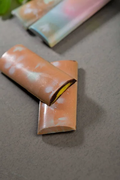 Handmade chocolate bonbons sliced on gray — Stock Photo, Image