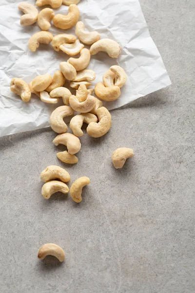 Cashew nuts on white paper — Stock Photo, Image