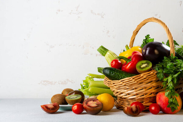 Fresh food in basket on white background, copy space