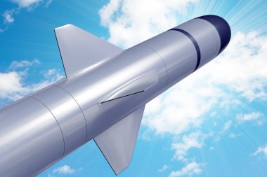 Combat tactical missile against the blue peaceful sky. clipart