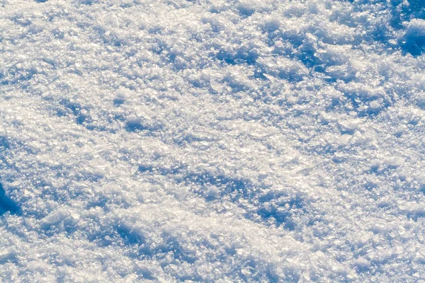 大きな氷の結晶の雪の表面 クローズアップ 太陽の下で異なる色で輝く — ストック写真