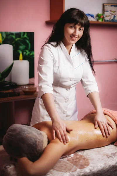 Woman massage therapist, with honey massage on the sides
