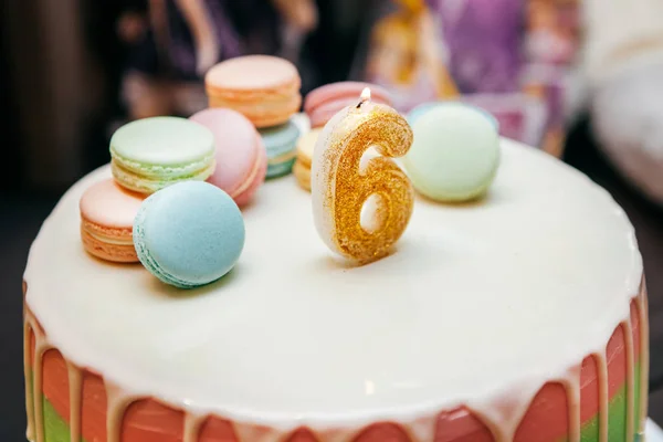 cake decorated with glaze, cookie with cream and  festive candle