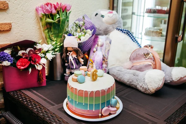 birthday presents of a child with flowers, cake and toys