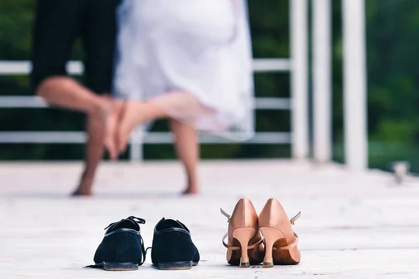 man and woman touch their feet to each other without shoes in the room