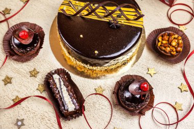 Tahta bir dokuda keklerin olduğu çikolatalı lezzetli bir pastanın üst görüntüsü.