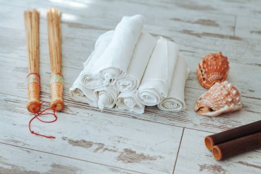 Masör aleti beyaz bir arka planda yerde yatıyor. Bandajdan katlanmış bir kabuk. Babmuokvy sopa ve fırça.