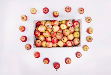 red apples in a box in the shape of a heart