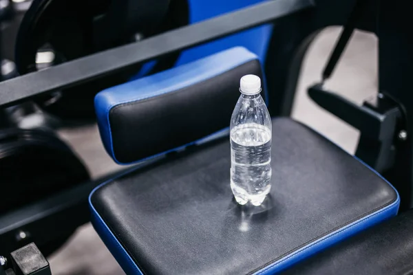 a bottle of water on a blue simulator stands